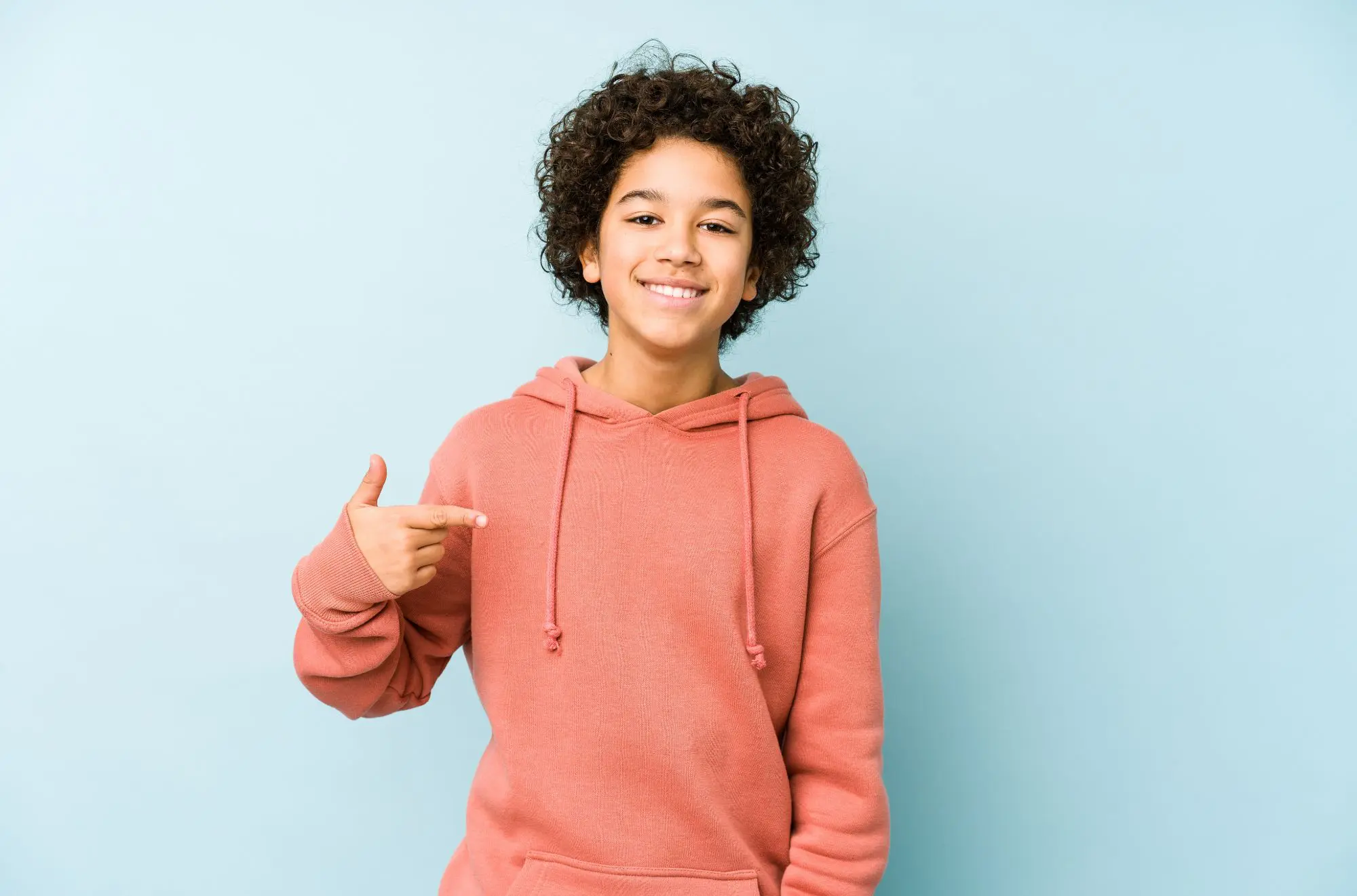A young boy stands showcasing the confidence gained from gentle laser dentistry at Pediatric Dentistry and Orthodontics of Forsyth - Cumming in Cumming, GA.
