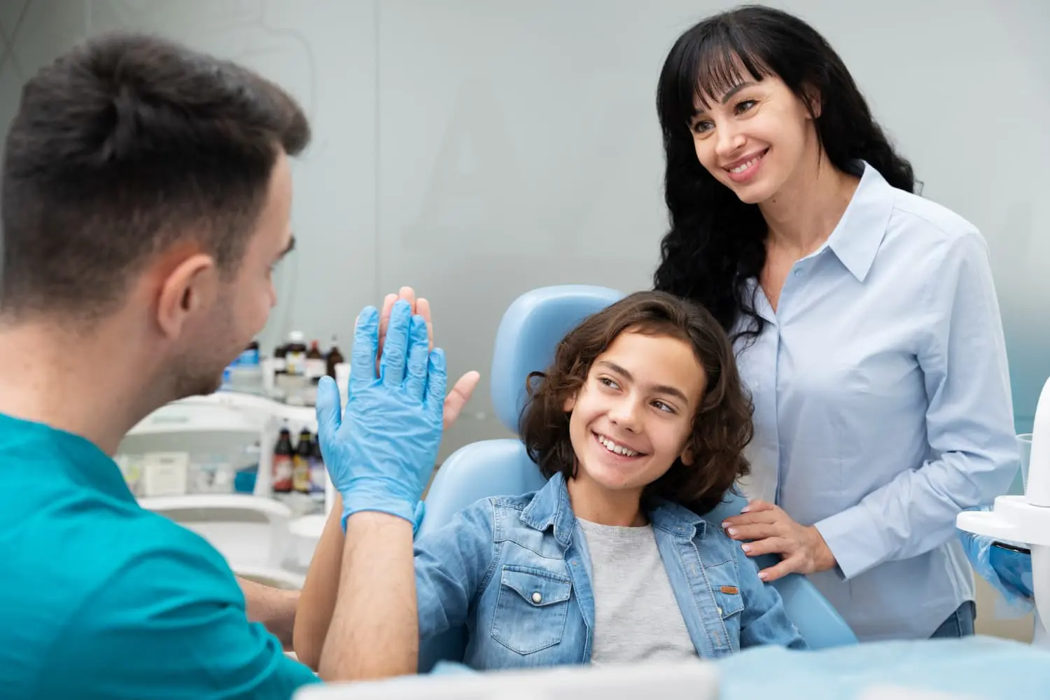 Young boy and parent smiles getting Flexible Scheduling for Working Parents for kids dental treatment from Pediatric Dentistry and Orthodontics of Forsyth - Cumming in Cumming, GA.