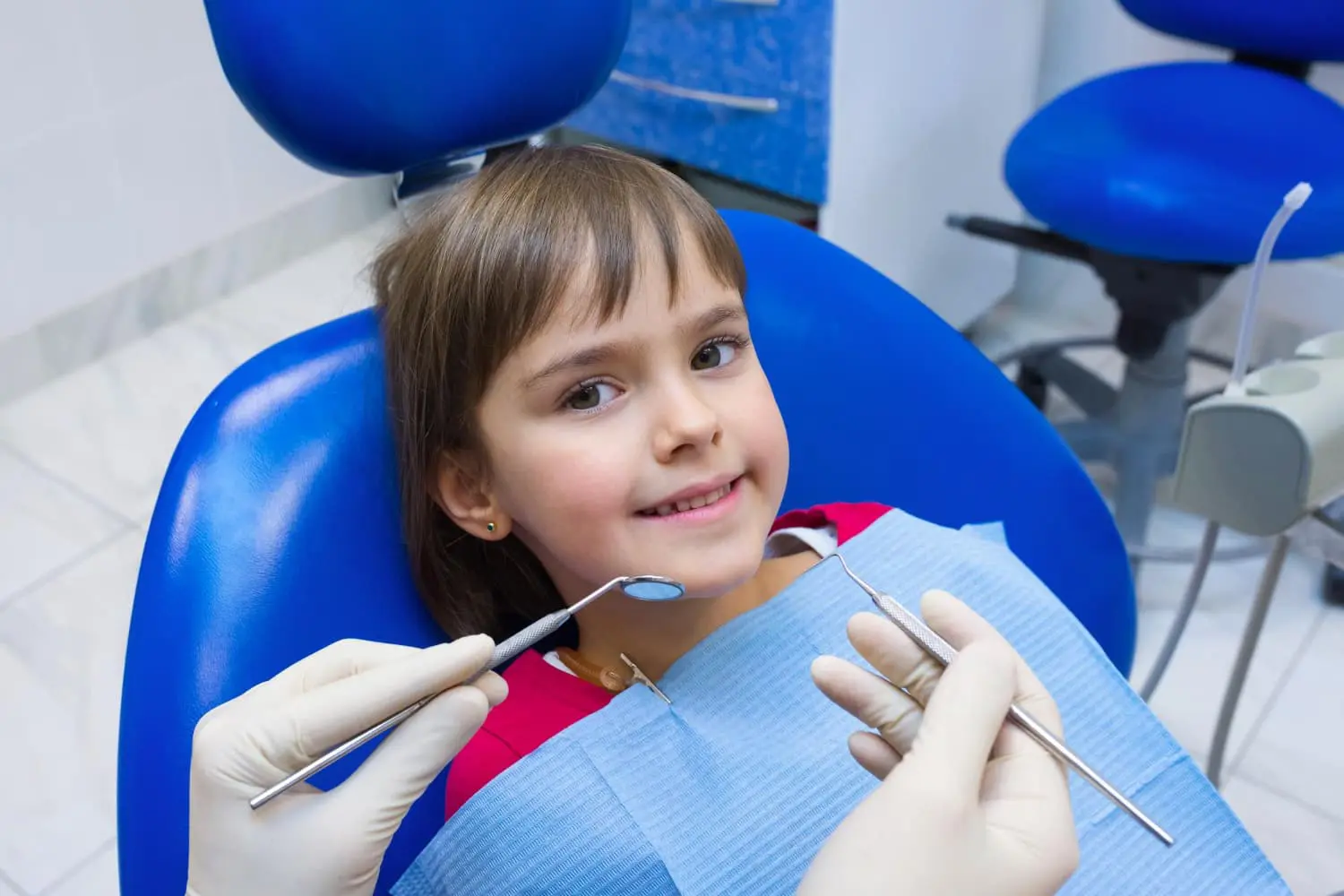 A Friendly Dentist discuss with patient at Pediatric Dentistry and Orthodontics of Forsyth - Cumming with young girl and welcome also for Special-Needs & Autism in Cumming, GA.