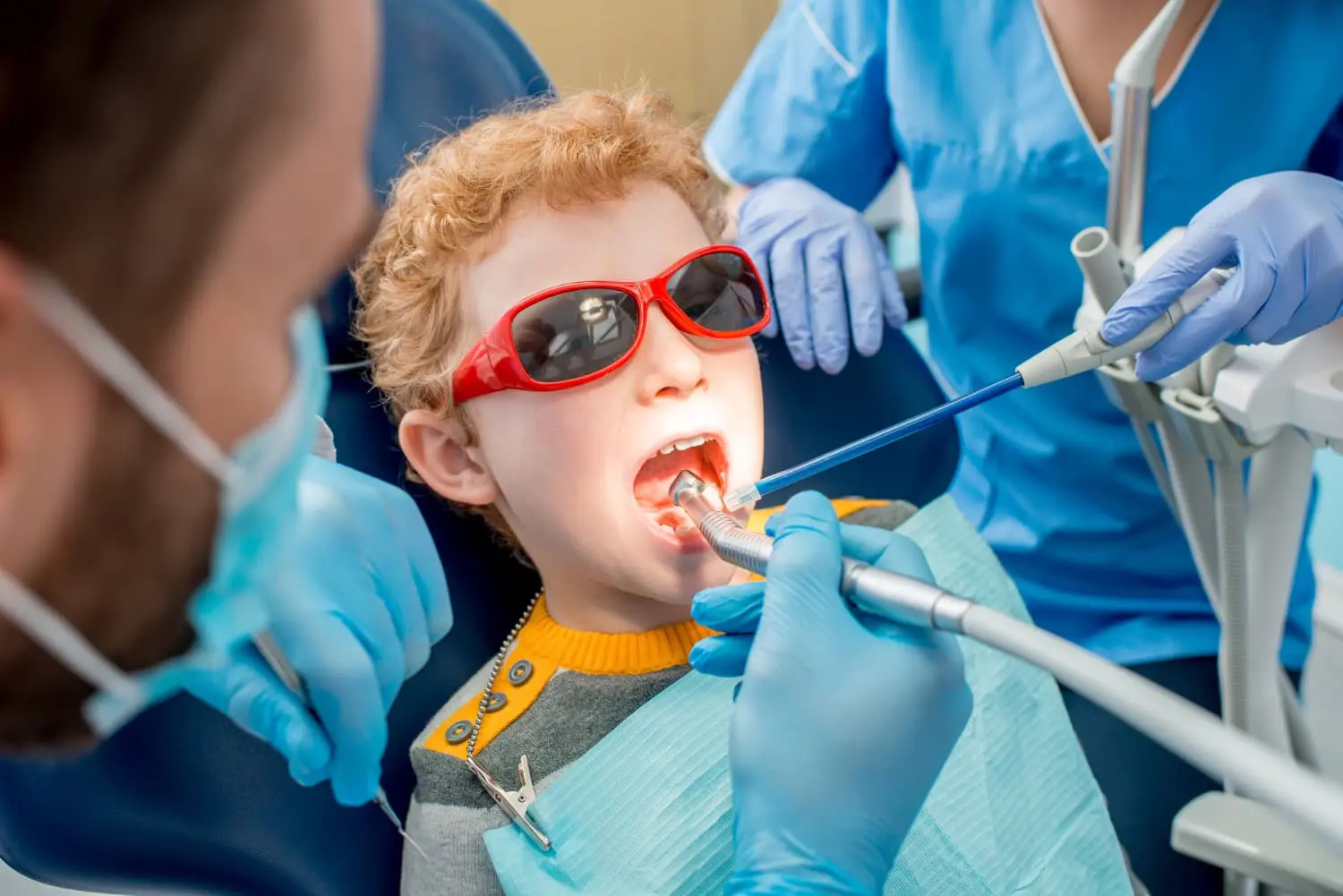 At Pediatric Dentistry and Orthodontics of Forsyth - Cumming in Cumming GA, a young boy Sit down in dental chair for Laser Dentistry with the dental professional no grinding or vibration, and no micro-fractures in surrounding enamel.