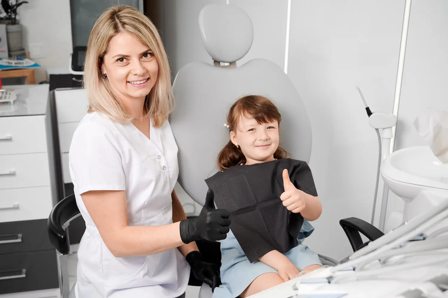 At Pediatric Dentistry and Orthodontics of Forsyth - Cumming in Cumming GA, a child sits in a modern clinic's dental chair and have technology that makes dentistry easier during dental treatment.
