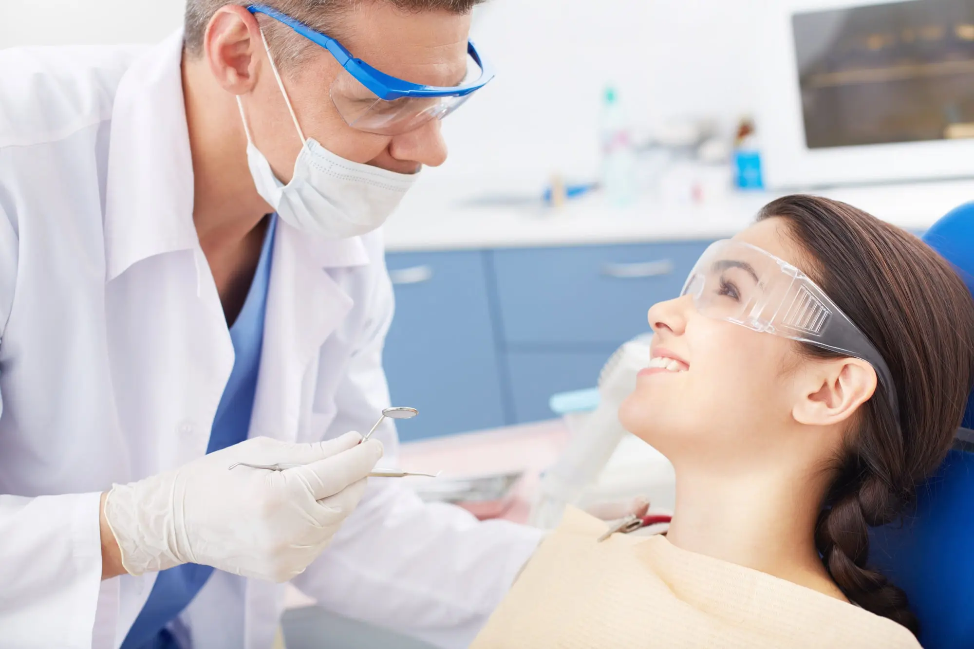 At Forsyth Pediatric Dentistry and Orthodontics in Cumming, GA, dentist and patient wear safety eyewear during an exam for jaw surgery.
