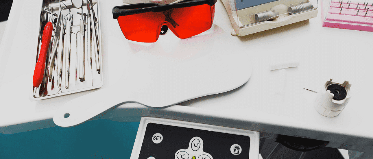 At Pediatric Dentistry and Orthodontics of Forsyth - Cumming in Cumming, GA, a tray displays dental tools, metal braces, and red safety glasses.