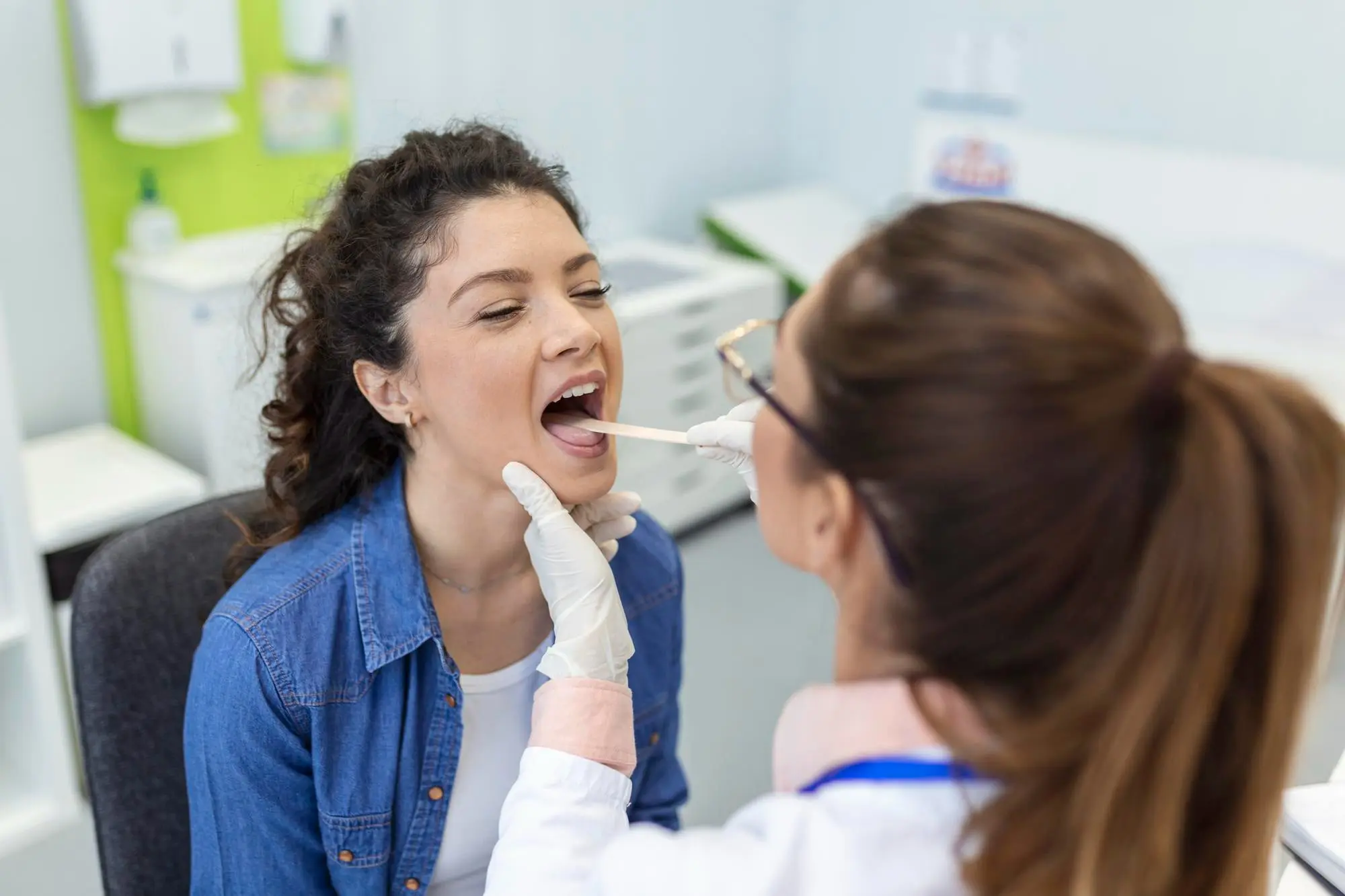 A healthcare professional at Forsyth Pediatric Dentistry and Orthodontics in Cumming, GA checks a patient’s for tongue thrust treatment.