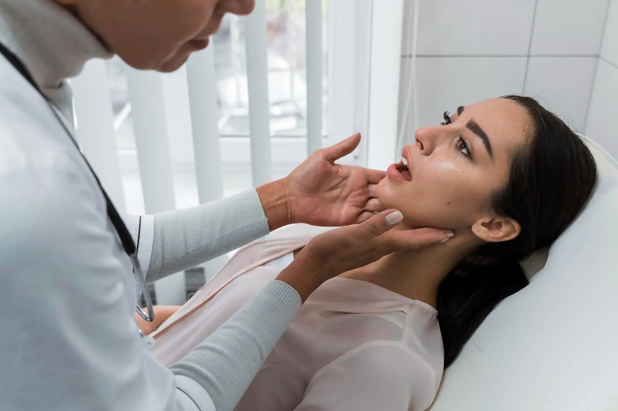 In Cumming, GA, at Forsyth Pediatric Dentistry and Orthodontics- a clinician examines a woman's jaw for corrective surgery.