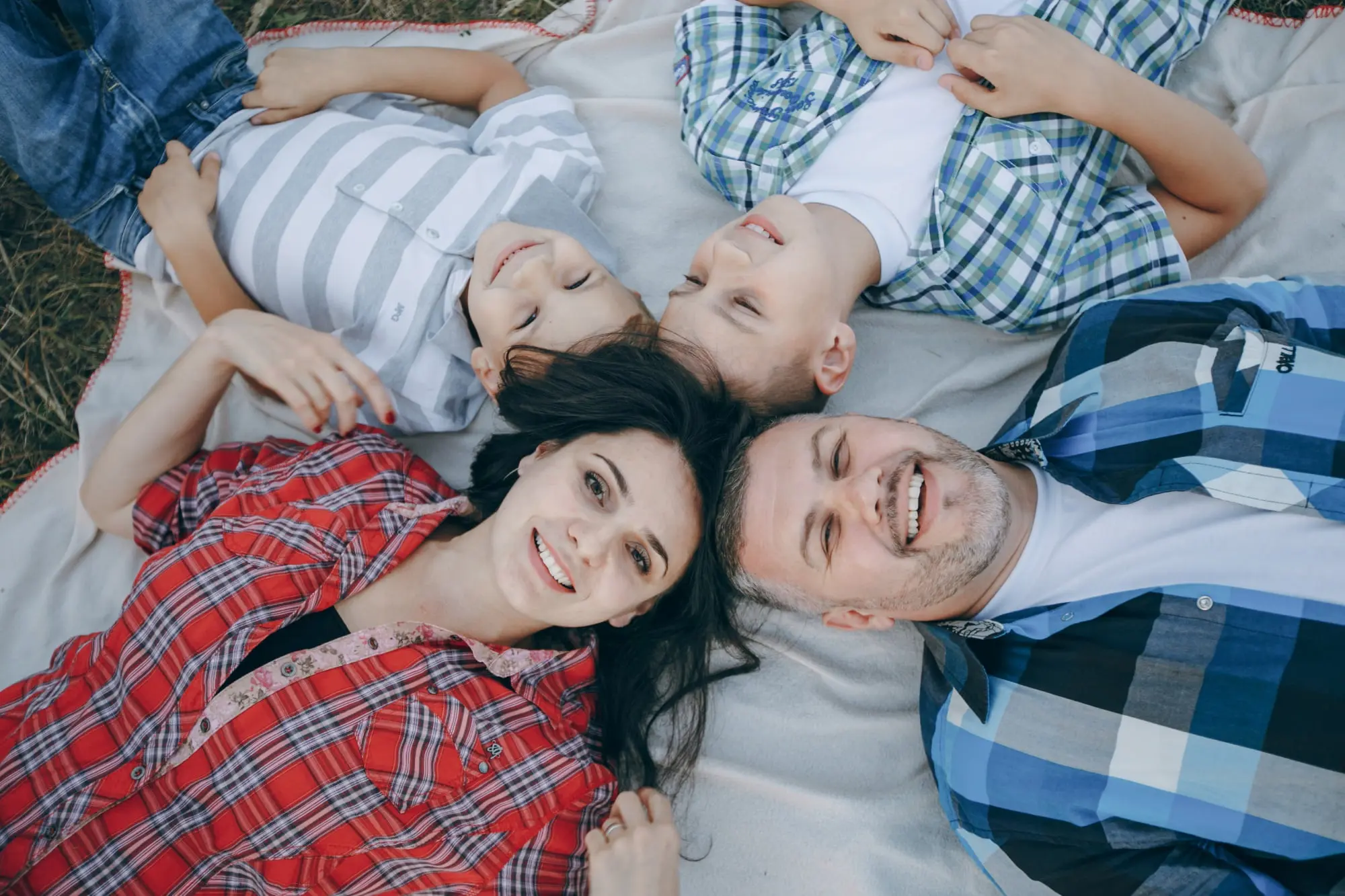 A family of four in Cumming, GA enjoys time outdoors discussing a TMJ Night Guard from Forsyth Pediatric Dentistry and Orthodontics.