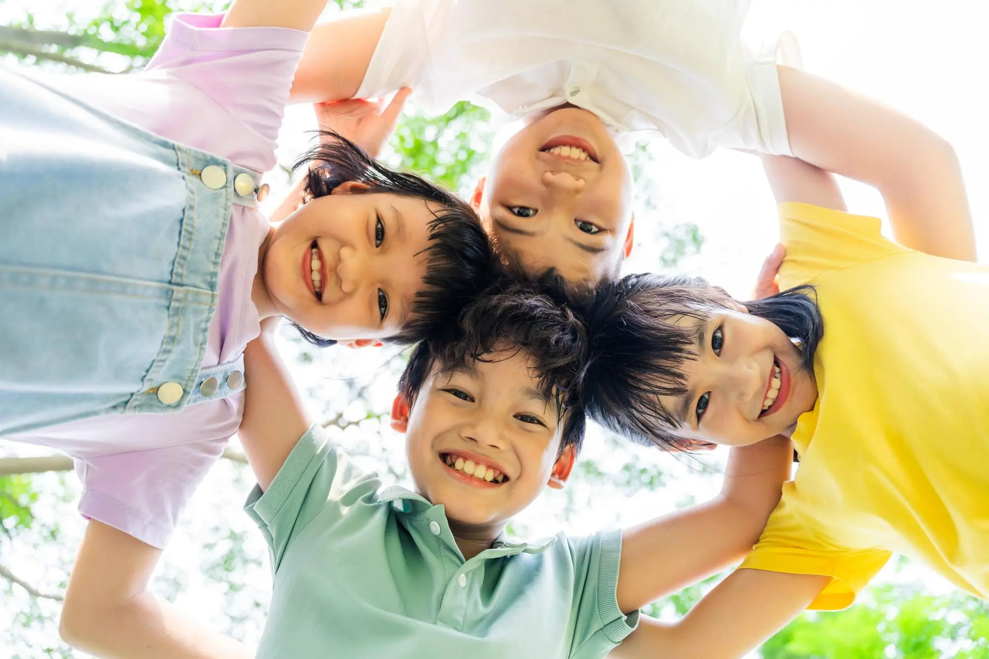 Smiling kids pose outdoors at Forsyth Pediatric Dentistry and Orthodontics in Cumming, GA, one displaying a new palatal expander.